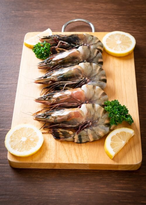 fresh tiger prawn or shrimp on wood board